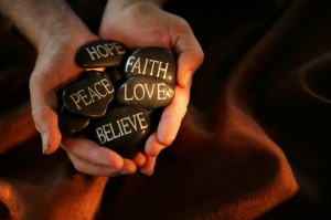 hands with words on stones